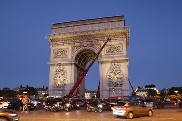 Dismantling work of a temporary art installation on the Arc de Triomphe in Paris