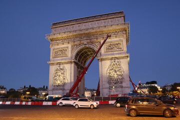 Dismantling work of a temporary art installation on the Arc de Triomphe in Paris