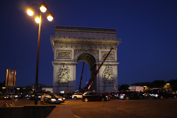 Dismantling work of a temporary art installation on the Arc de Triomphe in Paris