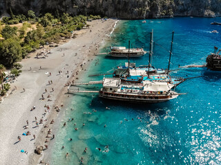 Fethiye beach. Areal view of the beach with clear water, boats and tourists in Butterfly Valley in the city of Oludeniz/Fethiye in western Turkey