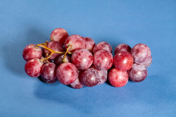 red grape on blue background