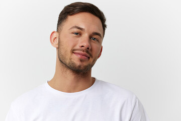 Cheerful cute happy young tanned handsome man in basic t-shirt smile at camera posing isolated on over white studio background. Copy space Banner Mockup. People emotions Lifestyle concept. Portrait