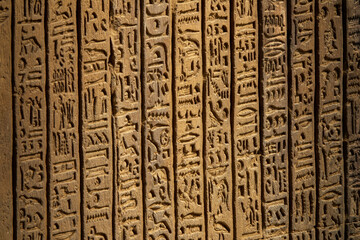 Ancient egypt hieroglyphics carving on wall of temple