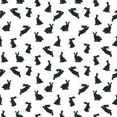Obraz na płótnie Canvas Hand drawn seamless pattern with cute black grey rabbits on a white background. Vector illustration