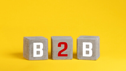 Business concept success process. concrete cube with letteres b2b, copy space.