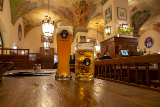 Munich, Germany - 04.07.2022: famous hofbräuhaus traditional pud keller in Munich 2 HB beer jugs Krügel