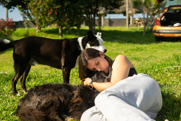 Woman playing with her dogs on the grass