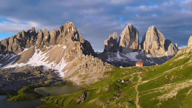 Aerial view of Tre Cime di lavaredo mountains and hut Locatelli with lake in Sexten Dolomites, Alps, South Tyrol, Italy. 4k drone video
