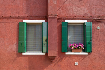 Fototapeta na wymiar Colorful window at Burano island Italy with a flower pot