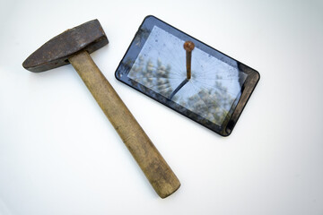 A rusty nail hammered into the LCD screen of the tablet.Destruction of information on electronic...