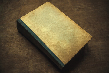 An old yellowed book on a wooden table. Antique library. Vintage manuscripts. A book with a clean...