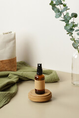 Amber glass spray bottle on wooden platform. Natural organic SPA cosmetic product packaging design,...