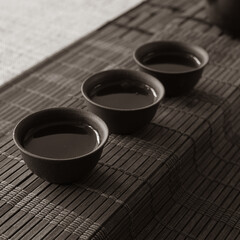 tea set on a table with a bamboo mat