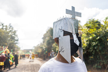 Portrait of a young Latino man dressed as a Roman soldier with a handmade silver painted cardboard helmet, participating in a Holy Week tradition known as the Jews of Masatepe in Nicaragua.