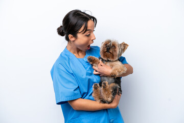 Young veterinarian woman with dog isolated on white background with surprise facial expression