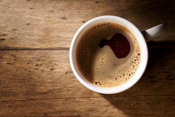 coffee in a white mug on a wooden background