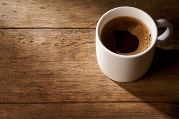 coffee in a white mug on a wooden background