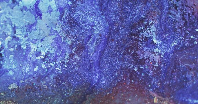 Glitter fluid texture. Paint mix. Ice frost pattern. Defocused blue purple color sparkling particles liquid flow decorative abstract background shot on RED Cinema camera.