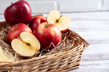 Fresh apples isolated in basket on wooden background under bright sunlight. Fresh natursl product....