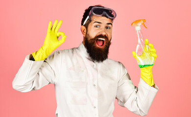 Professional cleaning service man in protective gloves with cleaning spray bottle showing sign ok.