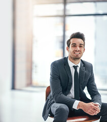 Happiness is a job that you love. Portrait of a happy young businessman posing in the office.