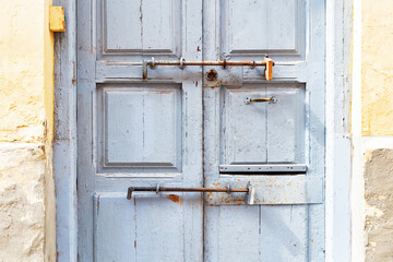 old blue door with old latch locks and window