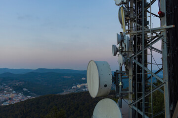 Telecommunications tower with cellular antennas and radar systems. Against the background of the...