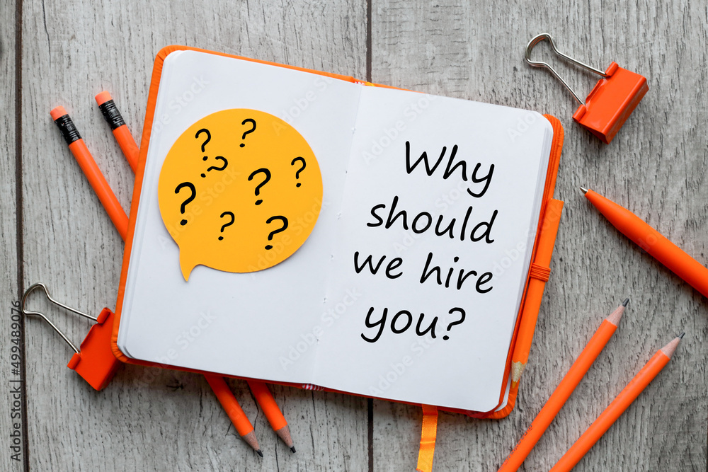 Poster why should we hire you ? text on orange notepad page