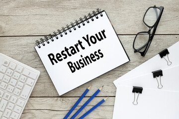 restart your business. light gray background with notepad. text on notebook