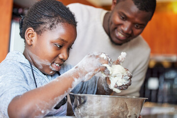 Learning can be a messy process. Shot of a father teaching his daughter how to bake in the kitchen...