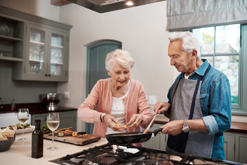 Marriage is all about teamwork. Cropped shot of a senior couple cooking together at home.