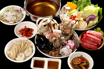 Ingredients for shabu-shabu cooking on a black background