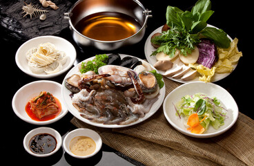 Ingredients for shabu-shabu cooking on a black background