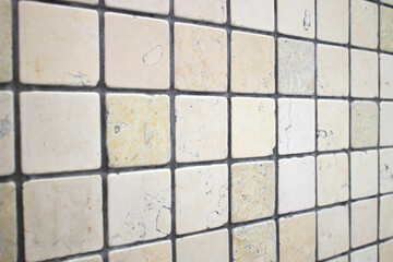 Beige ceramic mosaic square shape. Background of ceramic tiles. Ceramic tile with gray seams