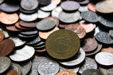 Costa Rica Foreign Currency Colones Coin with US Money in Background Texture Abstract Graphic Resource