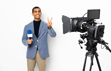 Reporter African American man holding a microphone and reporting news over isolated white background smiling and showing victory sign