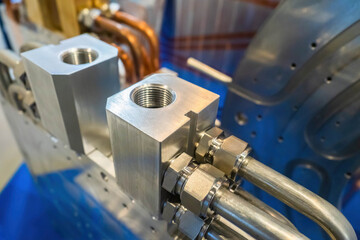 Close-up of the machine made of stainless steel and aluminum. Industrial equipment. Industry, production, automation. Equipment, cables and piping.