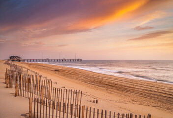 Sunrise over the beach and a fishing pier along the Outer Banks in North Carolina near Nags Head