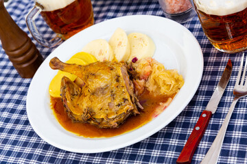 Grilled duck leg quarter with red and white cabbage. High quality photo