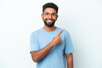 Young Brazilian man isolated on white background pointing to the side to present a product