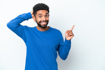 Fototapeta premium Young Brazilian man isolated on white background surprised and pointing finger to the side