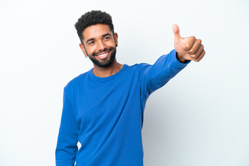 Fototapeta premium Young Brazilian man isolated on white background giving a thumbs up gesture