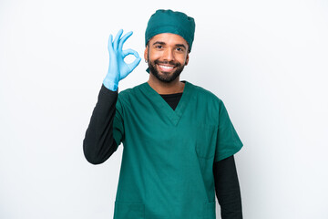 Surgeon Brazilian man in green uniform isolated on white background showing ok sign with fingers