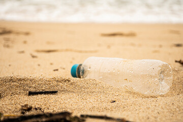 pet bottle on the beach sand. Garbage and human pollution on the beaches nature