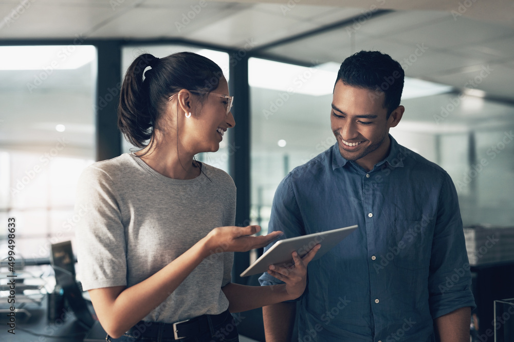 Poster love is for kids. compatibility is for adults. shot of two young workers using a digital tablet in a