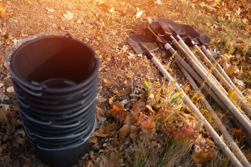 closeup of plastic bucket and shovel on ground or gardening tools for planting