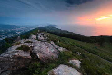 Fototapeta na wymiar Sunset at the sea seen from the top of Jaizkibel mountain at the basque coast.