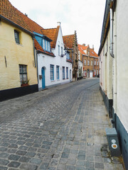 Historical street with small medieval brick houses in Bruges town, Belgium
