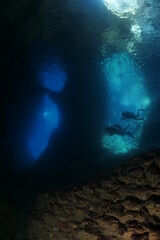 Fototapeta na wymiar cave dive underwater exploring blue caves ocean scenery scuba divers to explore