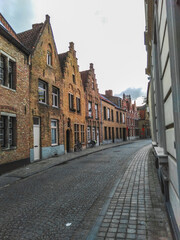 Fototapeta na wymiar Historical street with medieval brick houses in Bruges town, Belgium